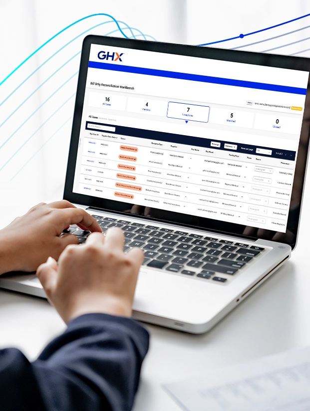 Hands typing on a laptop showing the GHX bill-only reconciliation workbench